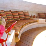 Built in seating with lush pillows in dining/swimming area