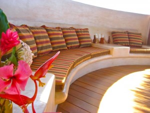 Built in seating with lush pillows in dining/swimming area